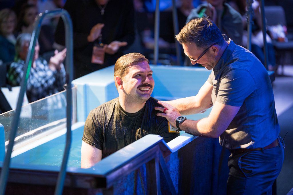 Man smiling getting baptized at Grace Point Church